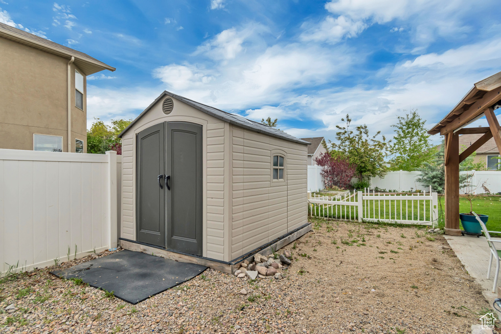 View of shed with a fenced backyard