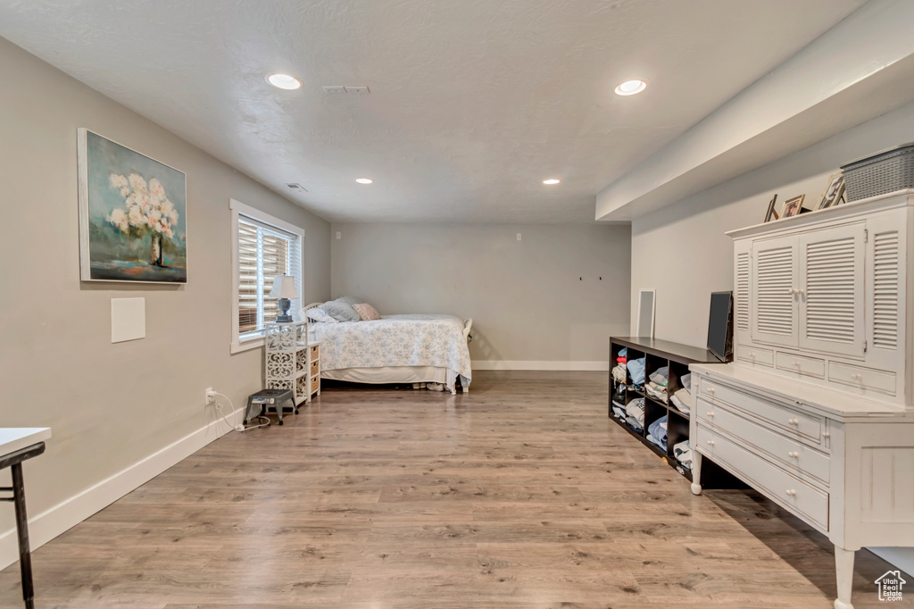 Bedroom featuring baseboards, light wood-type flooring, and recessed lighting