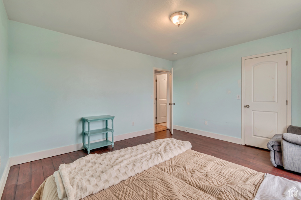 Bedroom featuring baseboards and dark wood-style flooring