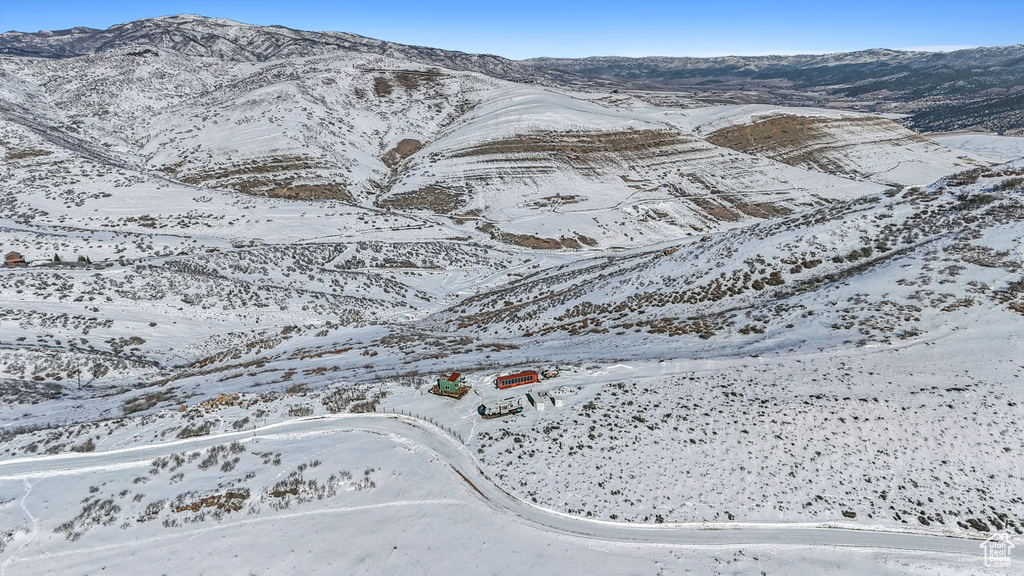 Snowy aerial view featuring a mountain view