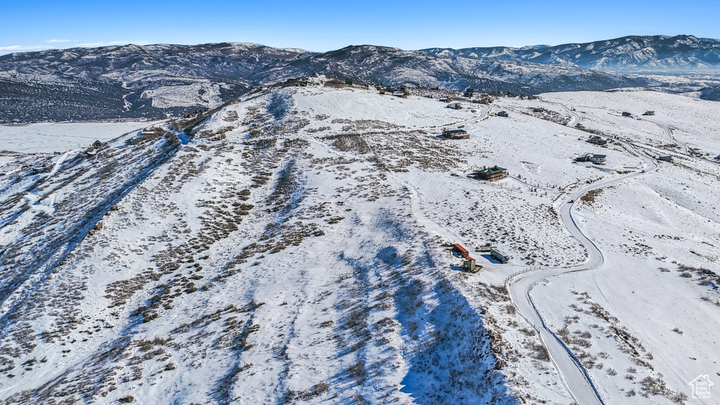 Snowy aerial view featuring a mountain view
