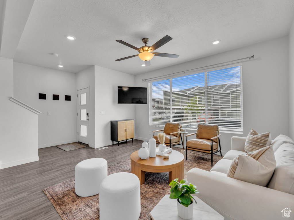 Living area featuring ceiling fan, recessed lighting, baseboards, and wood finished floors