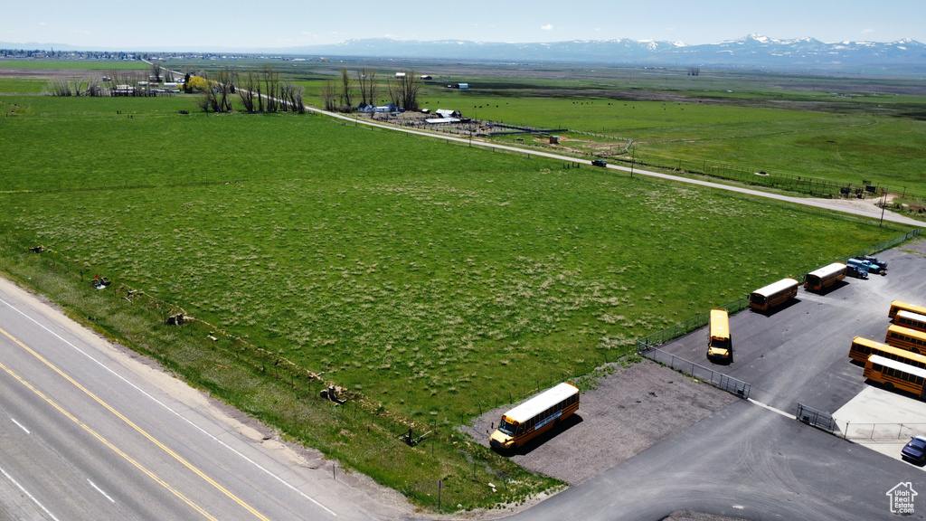 Aerial view of sparsely populated area featuring agricultural land and mountains