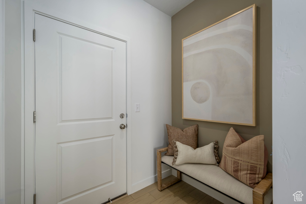 Foyer entrance with light wood-style flooring and baseboards