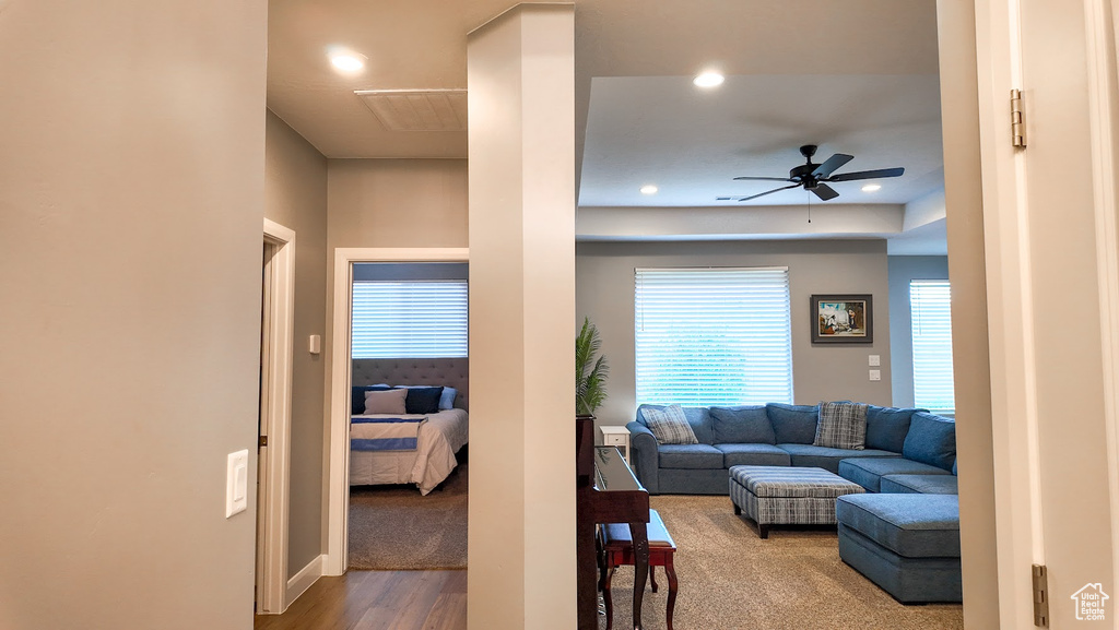 Living area with a ceiling fan, recessed lighting, and wood finished floors