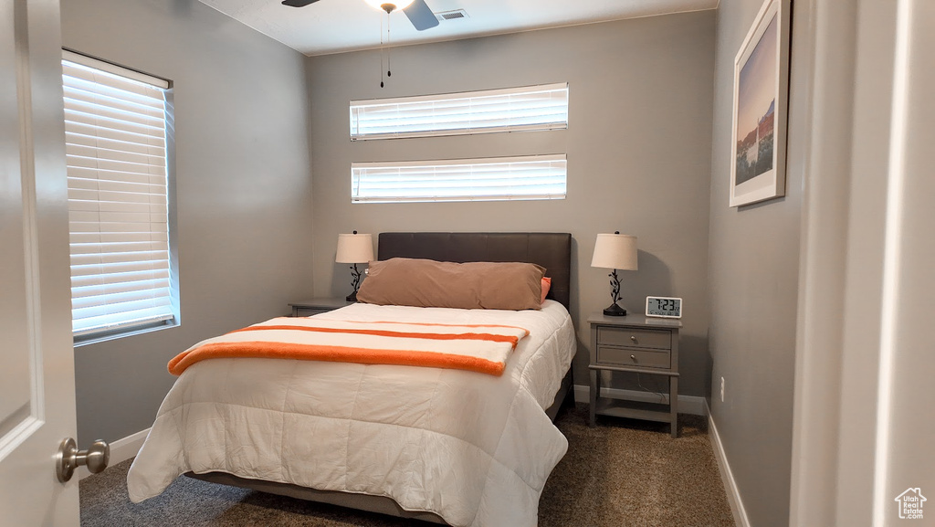 Bedroom featuring visible vents, baseboards, ceiling fan, and carpet floors