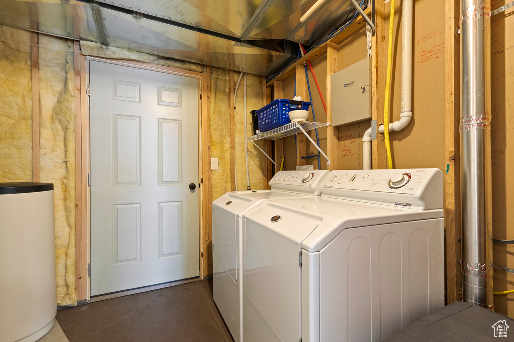 Laundry room featuring laundry area, independent washer and dryer, and gas water heater