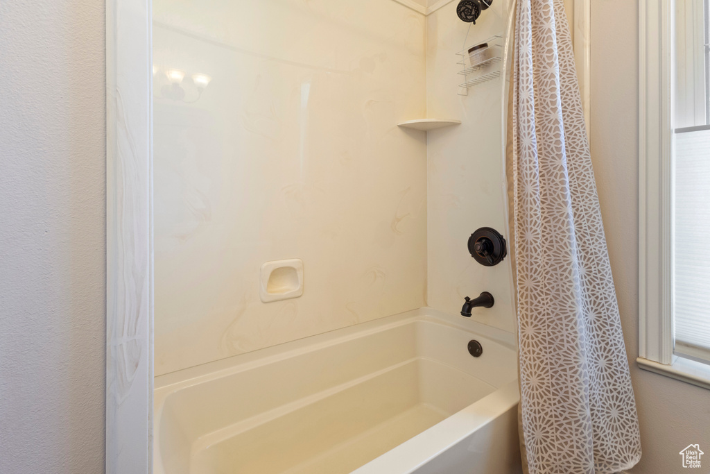 Full bathroom with shower / bathtub combination with curtain