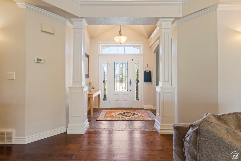 Entryway with hardwood / wood-style flooring, baseboards, ornate columns, and visible vents