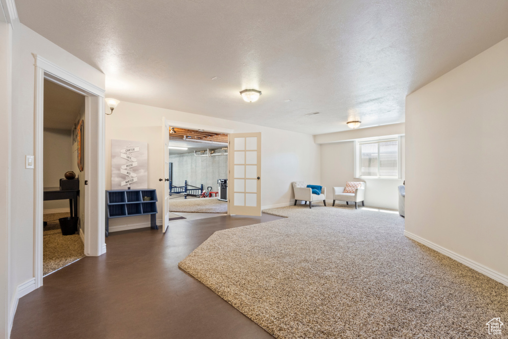 Rec room featuring baseboards and french doors