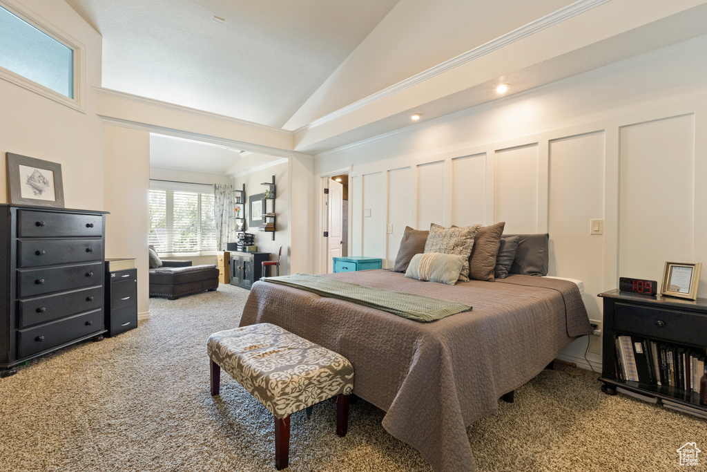 Carpeted bedroom featuring vaulted ceiling