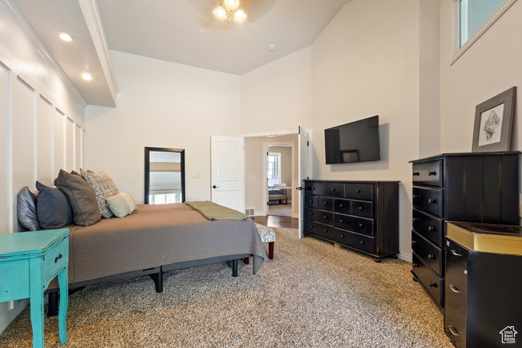 Bedroom with recessed lighting, a towering ceiling, and carpet floors