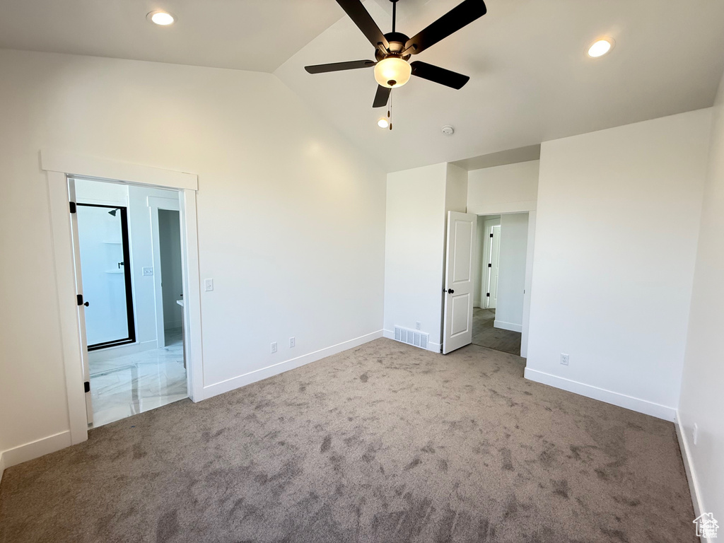 Unfurnished bedroom featuring lofted ceiling, baseboards, visible vents, and carpet