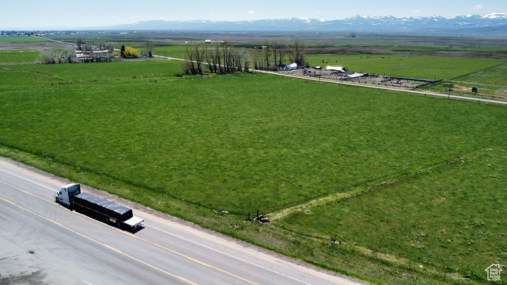 Aerial view of sparsely populated area with a mountain backdrop and agricultural land
