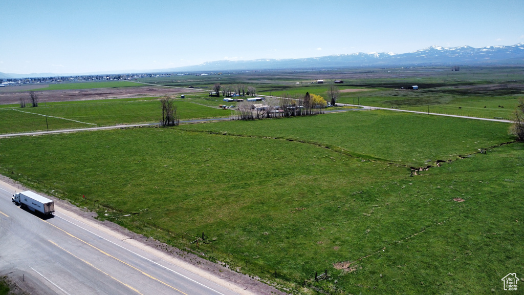 Overview of rural landscape featuring a mountain backdrop and a pastoral area