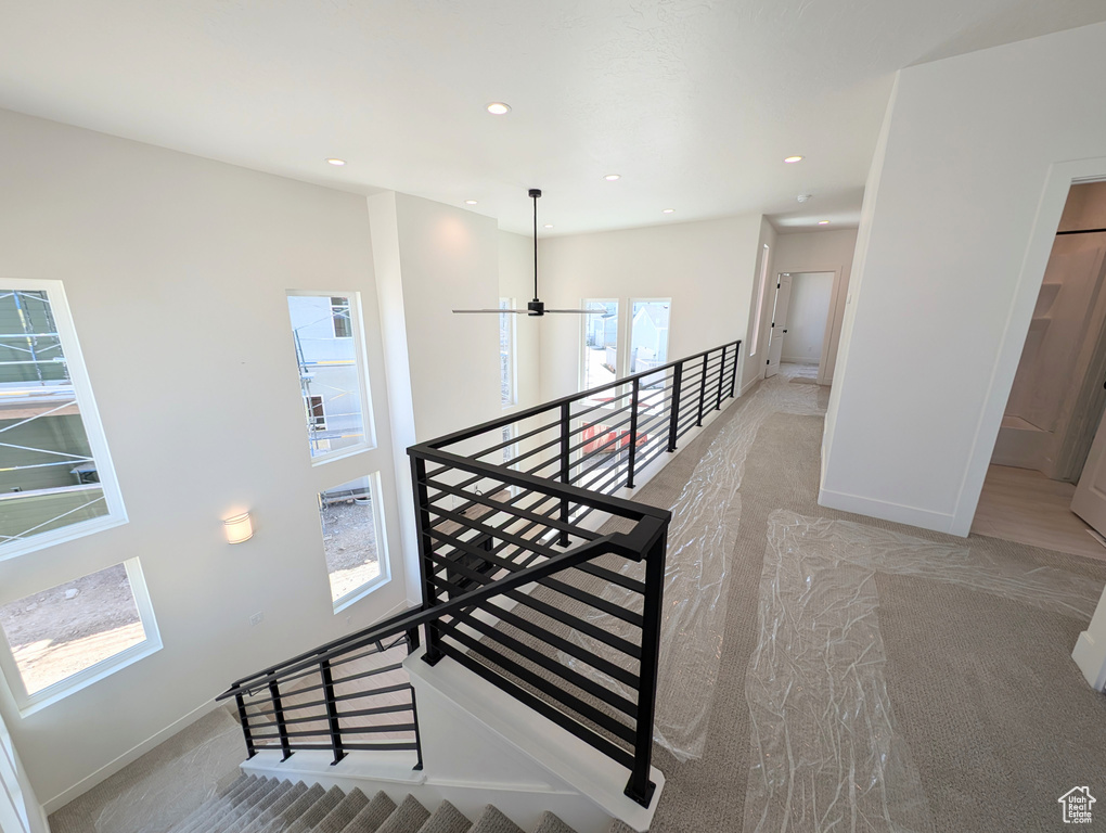 Staircase featuring recessed lighting, baseboards, and carpet floors