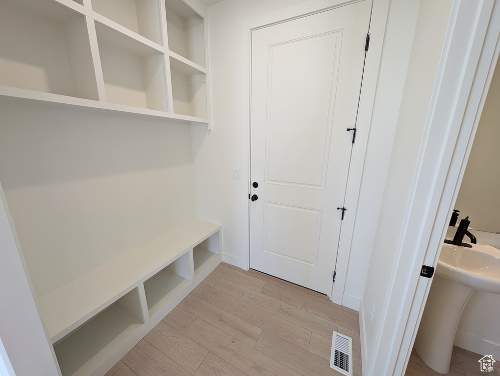 Mudroom featuring light wood finished floors, visible vents, and baseboards