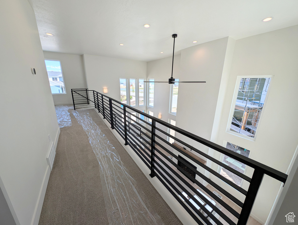 Hall with baseboards, an upstairs landing, recessed lighting, and carpet floors