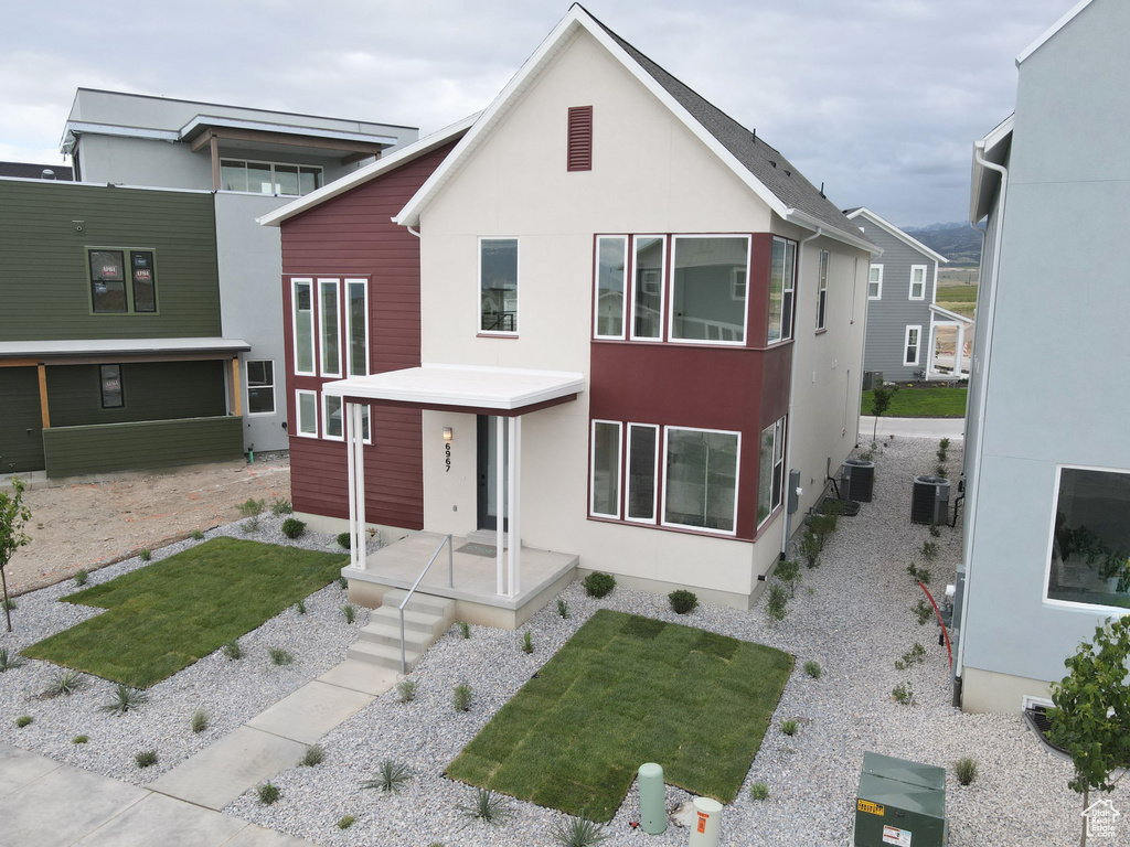 Modern home featuring central air condition unit and stucco siding