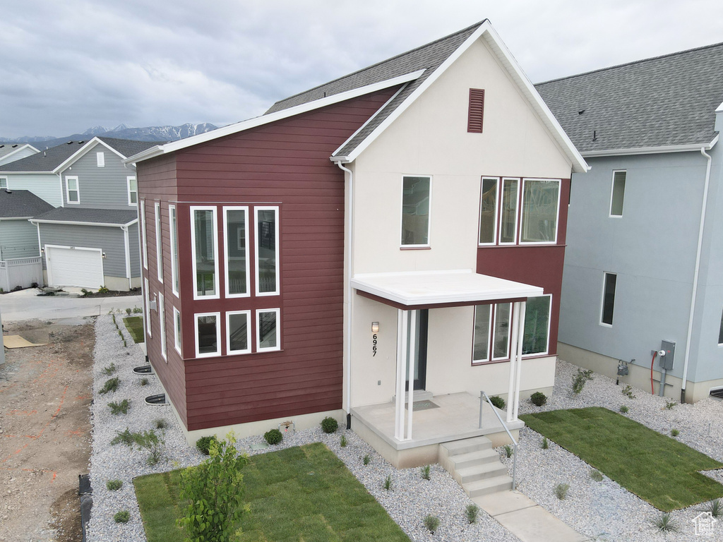 Contemporary house featuring stucco siding and a front lawn