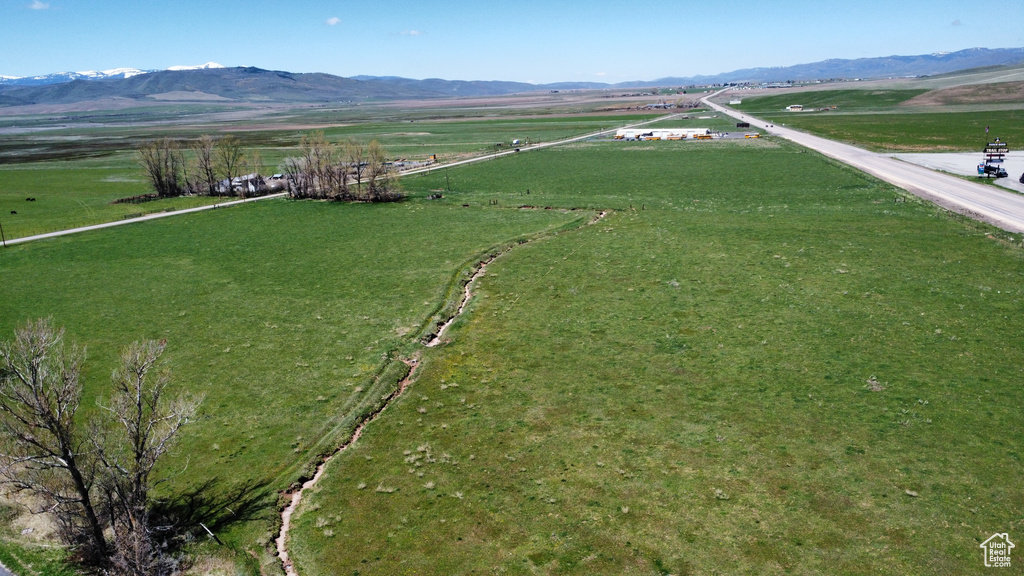 View of rural area featuring a mountainous background and agricultural land
