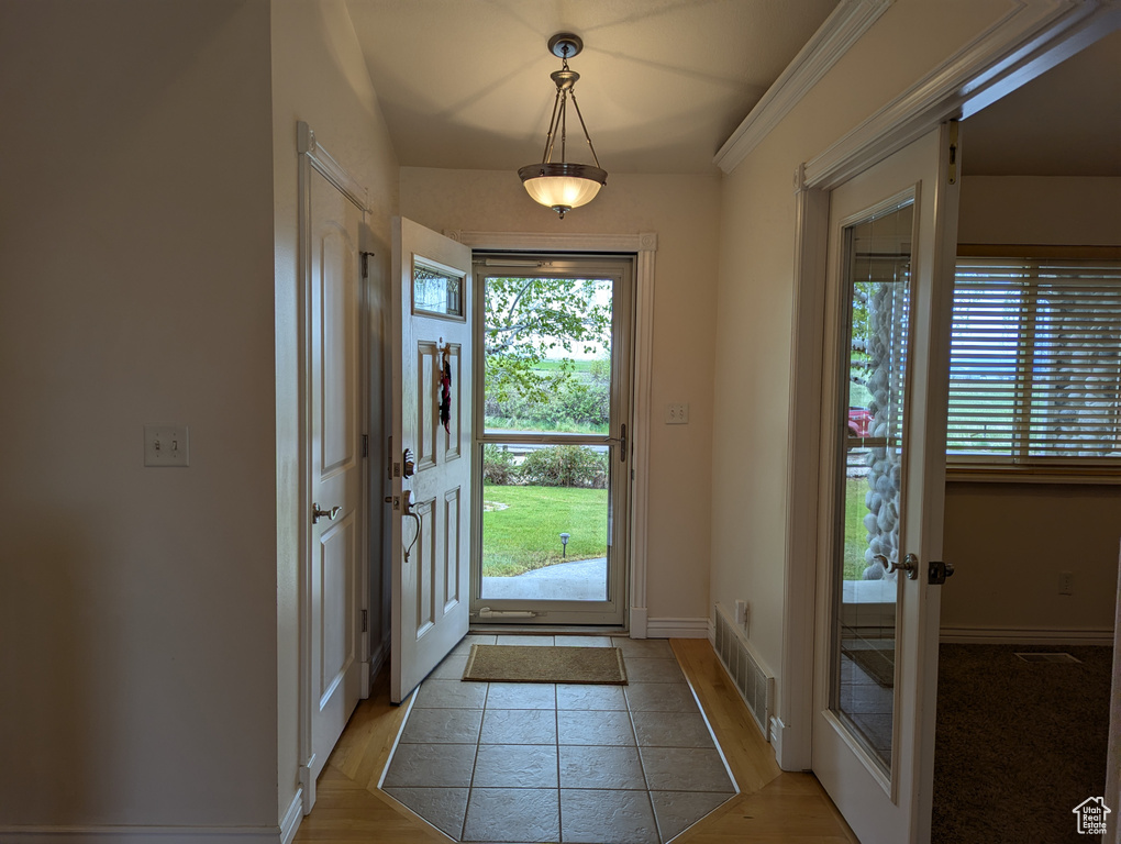Foyer with a healthy amount of sunlight, baseboards, french doors, and visible vents