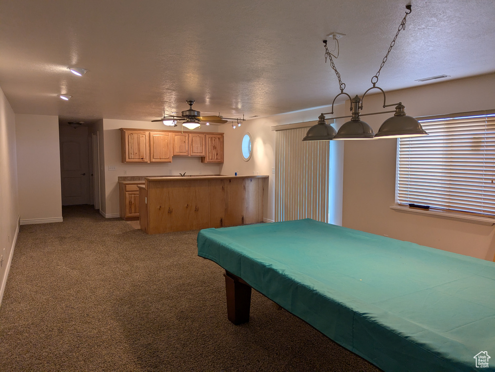 Rec room with a ceiling fan, a textured ceiling, baseboards, visible vents, and light carpet