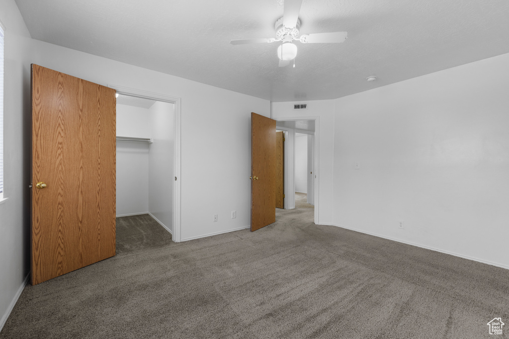 Unfurnished bedroom featuring baseboards, visible vents, and carpet floors
