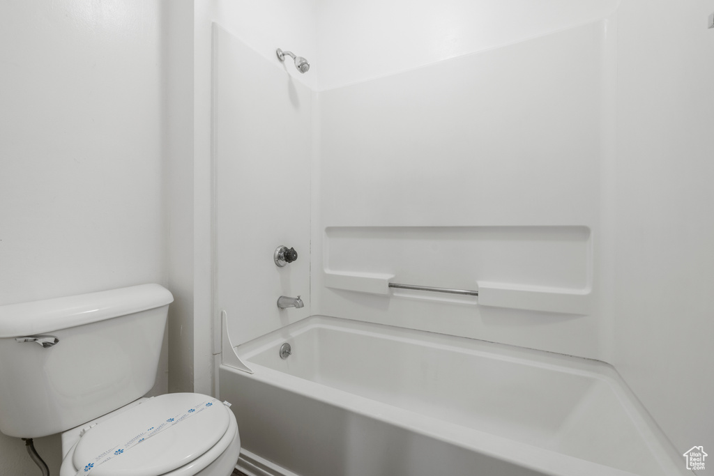 Full bath featuring toilet and tub / shower combination