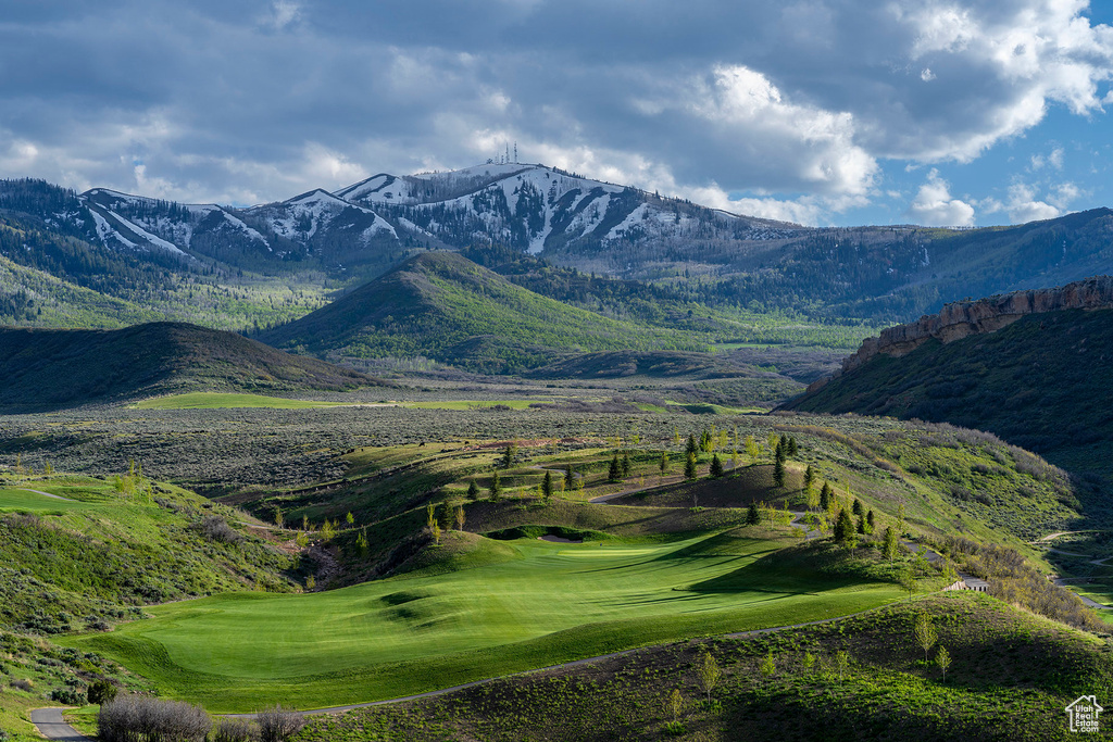 Property view of mountains with view of golf course