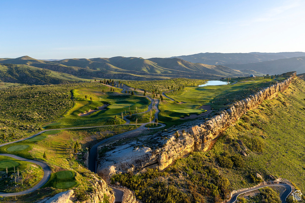 Mountain view with view of golf course and a water view