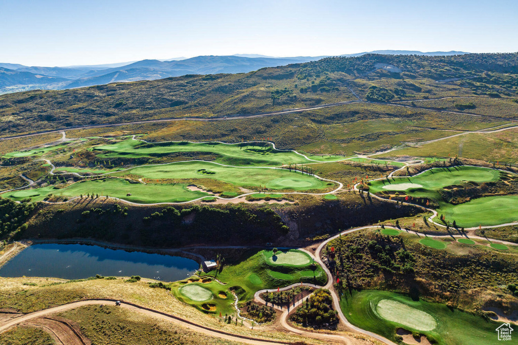 Bird's eye view featuring view of golf course and a water and mountain view