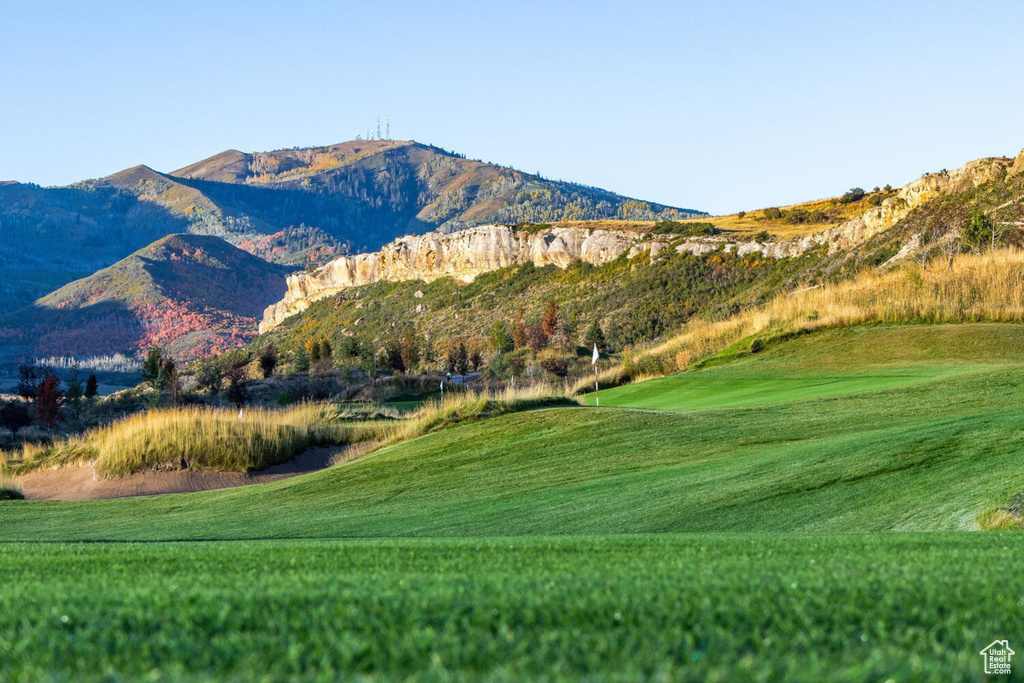 Property view of mountains featuring view of golf course