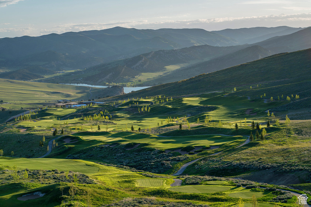 Mountain view featuring view of golf course and a water view