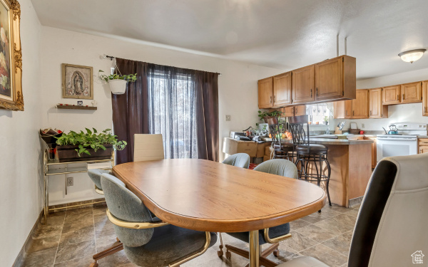 Dining space featuring stone finish flooring