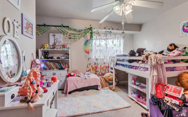 Bedroom featuring ceiling fan and carpet floors