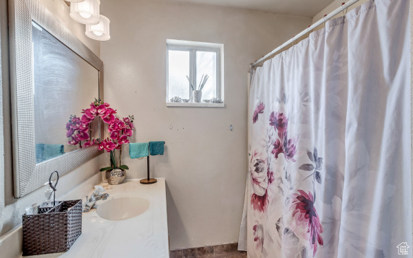 Bathroom featuring vanity and a shower with shower curtain
