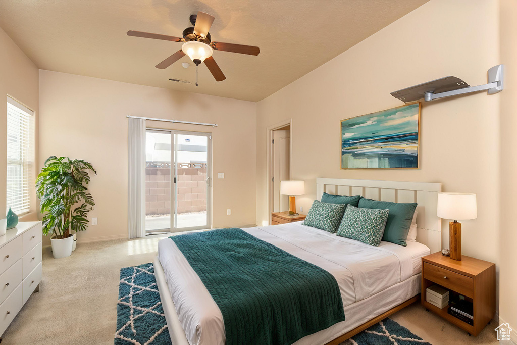 Bedroom with a ceiling fan, access to exterior, carpet floors, visible vents, and baseboards