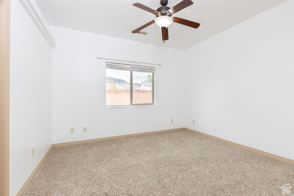 Unfurnished room with carpet floors, a ceiling fan, and baseboards