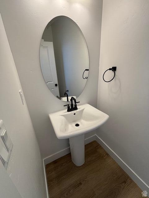 Bathroom featuring baseboards and wood finished floors
