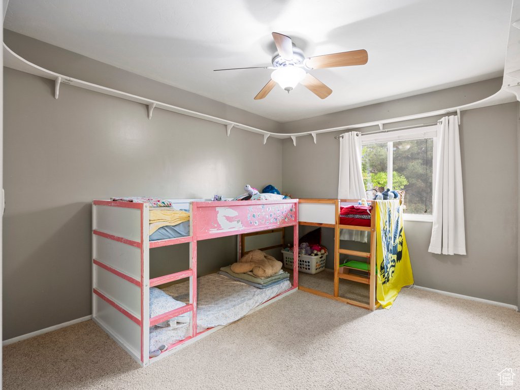 Bedroom with carpet, baseboards, and a ceiling fan