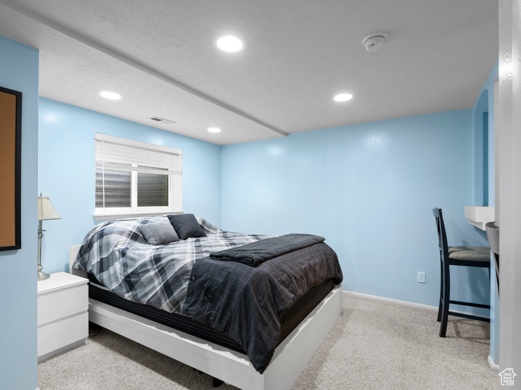 Carpeted bedroom featuring baseboards, recessed lighting, and visible vents