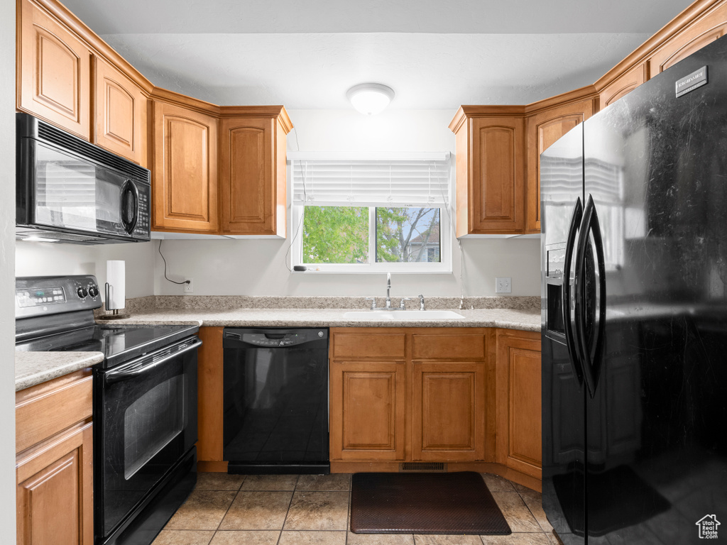 Kitchen featuring a sink, black appliances, visible vents, light countertops, and light tile patterned floors