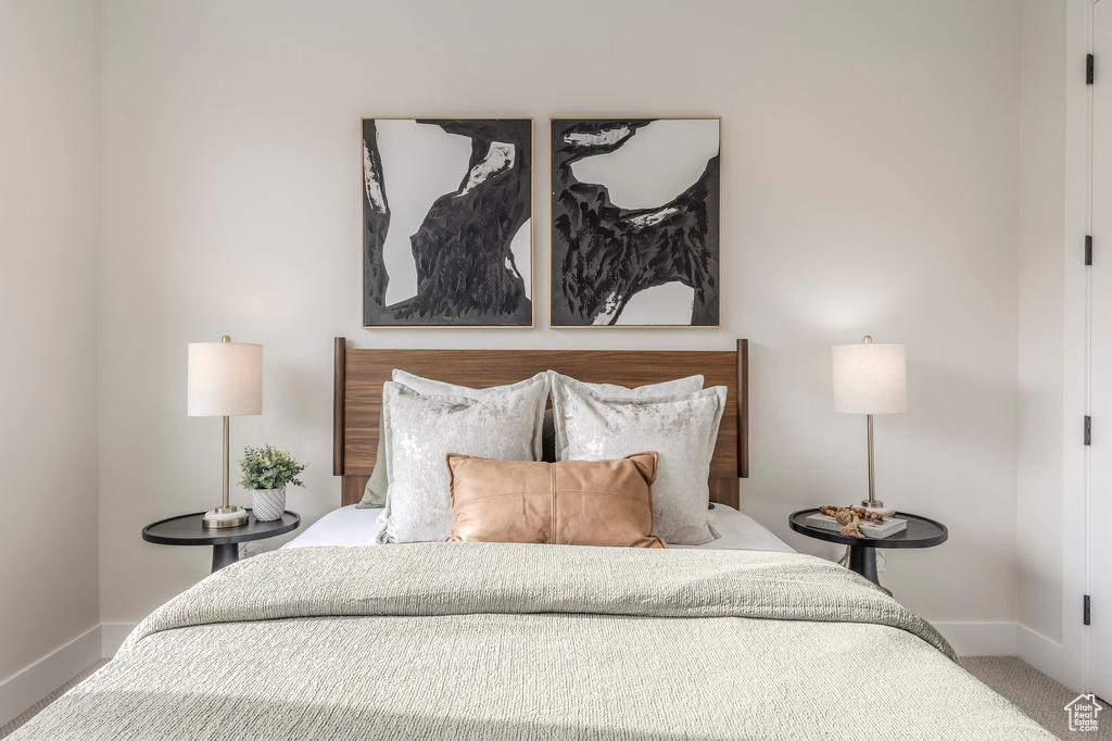Carpeted bedroom featuring baseboards