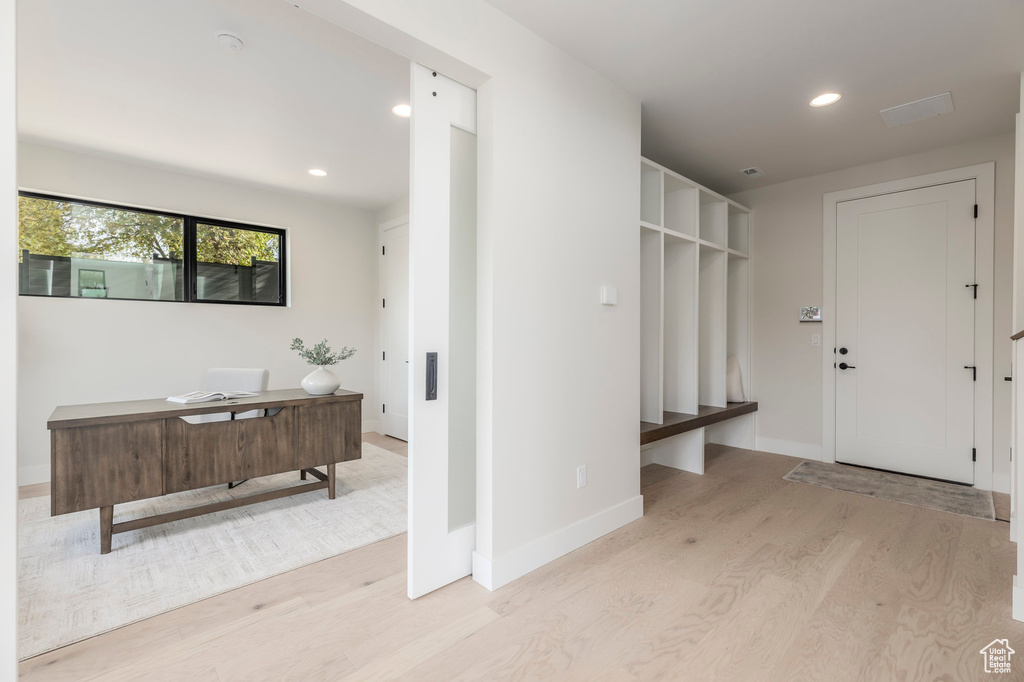 Mudroom with light wood-style flooring, baseboards, and recessed lighting