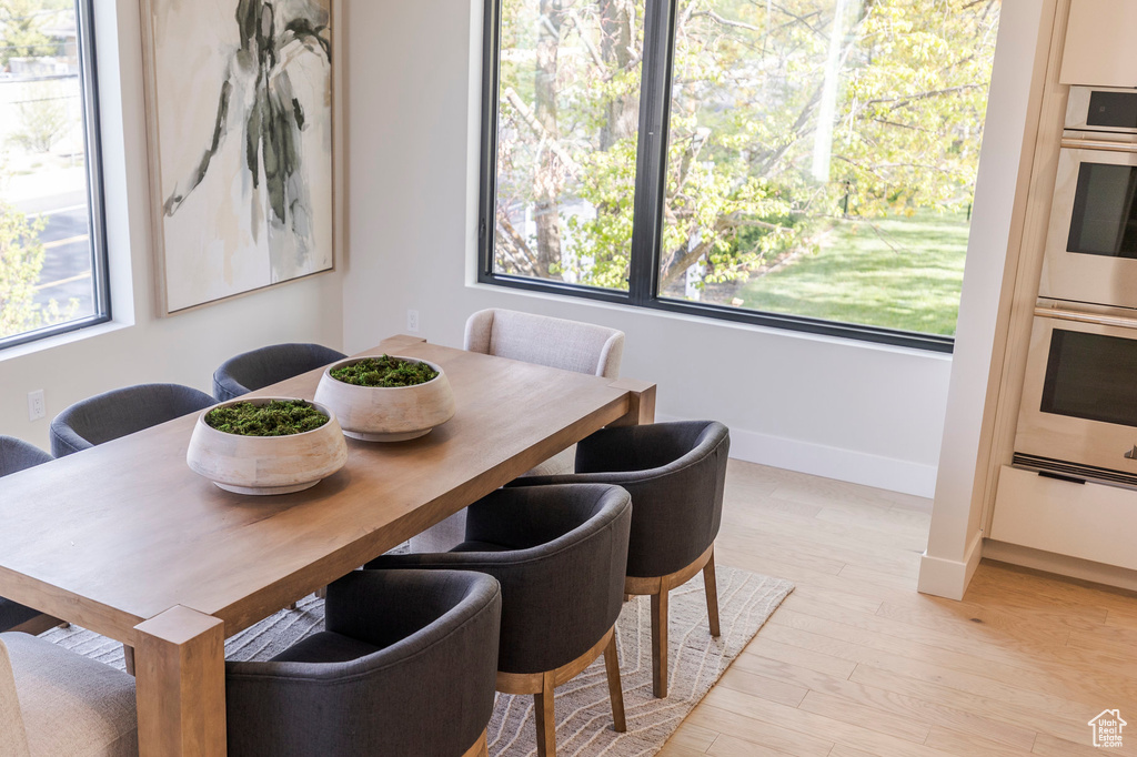 Dining room with light wood-style flooring and baseboards