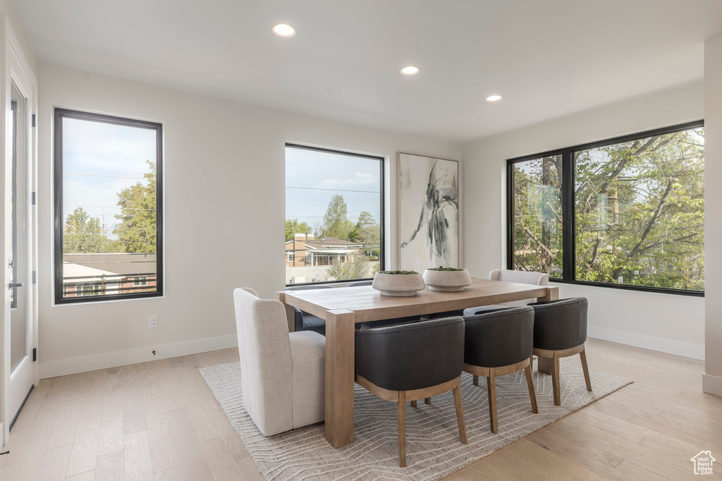 Dining room featuring baseboards, light wood-style flooring, and recessed lighting