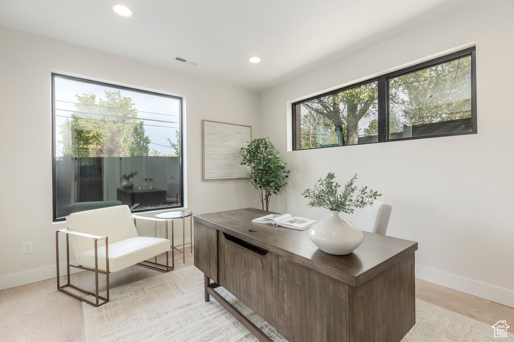 Home office featuring visible vents, baseboards, light wood-style flooring, and recessed lighting