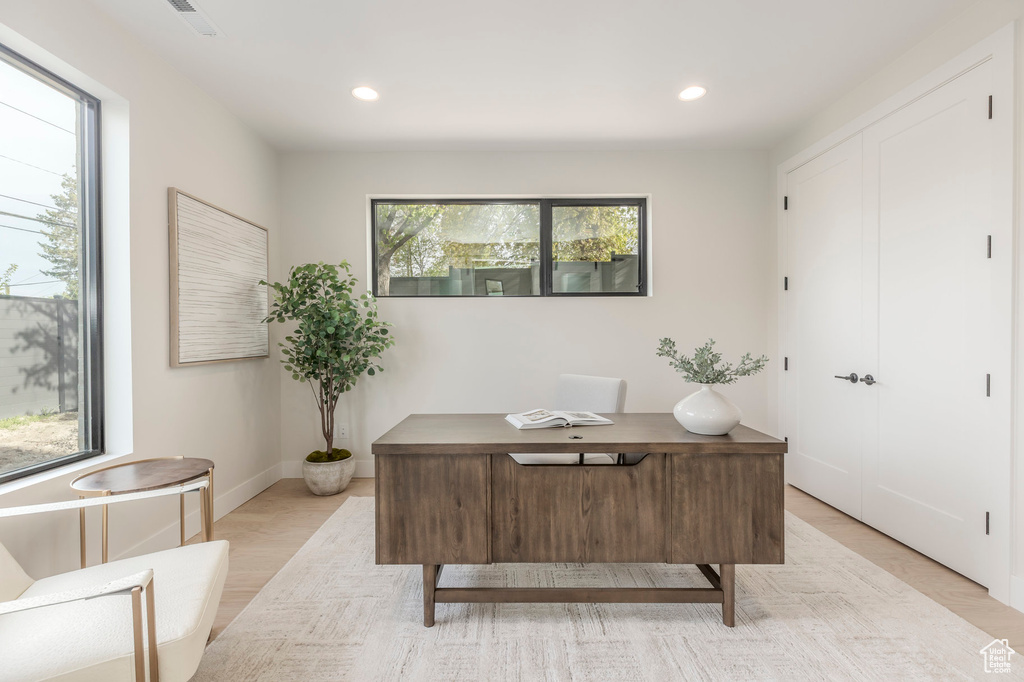 Home office featuring light wood-type flooring, recessed lighting, and plenty of natural light