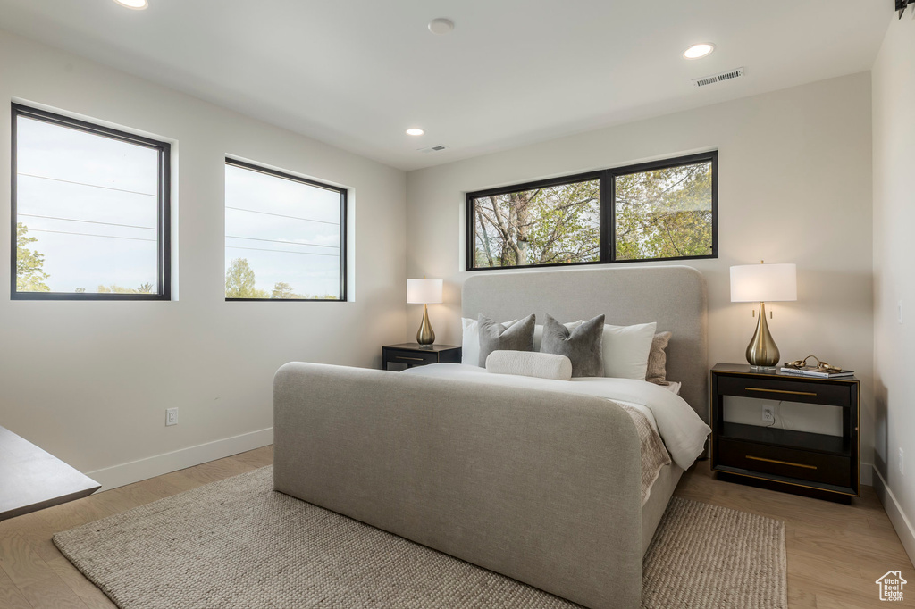 Bedroom featuring baseboards, recessed lighting, light wood-type flooring, and visible vents